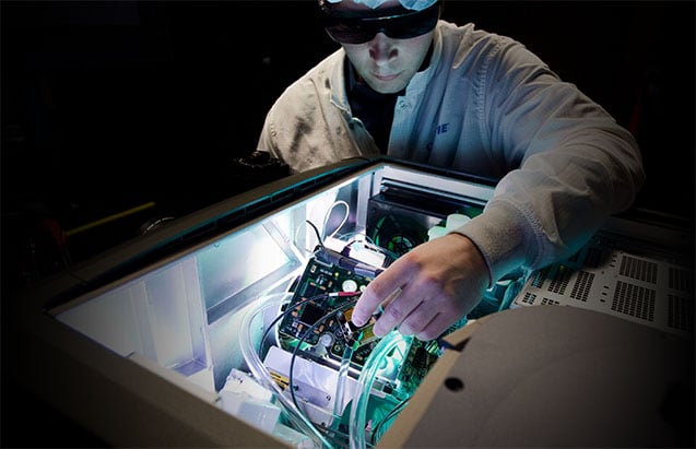 A technician performing maintenance on a projector