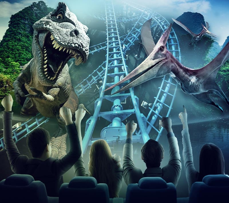 Four people on an immersive theme park ride with two projected images of dinosaurs