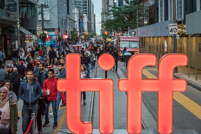 Large red letters spell TIFF in the middle of a busy street.