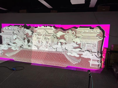 Image of a 3D wall in beige projected onto a screen with a pink background.