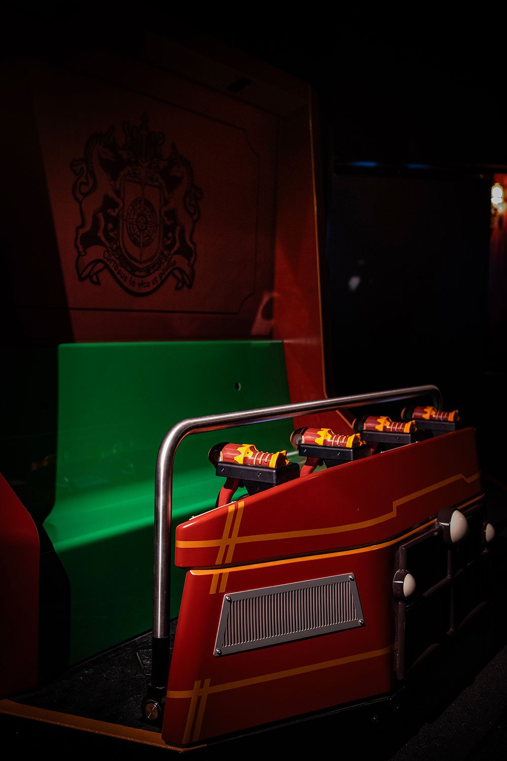 A red ride vehicle with a green seat.