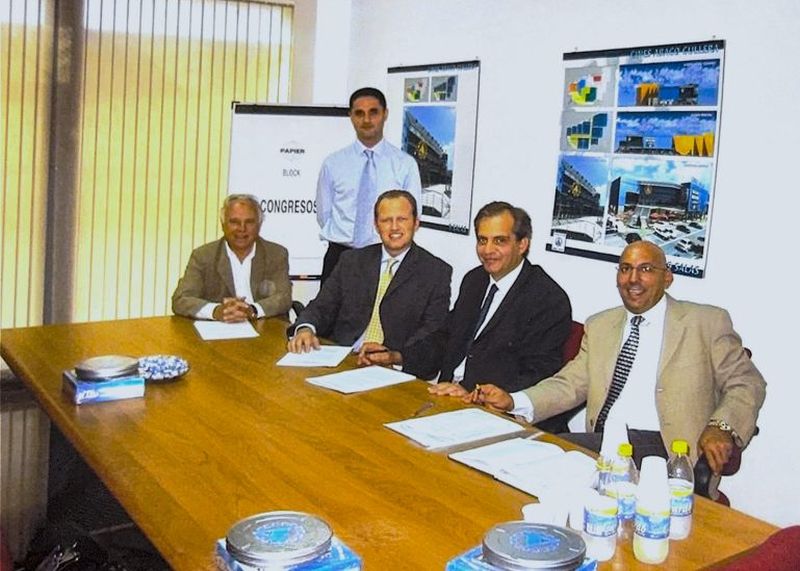 A group of men around a boardroom table.