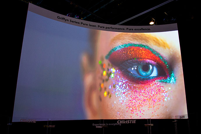 Large screen with colorful projection of an eye on it.  